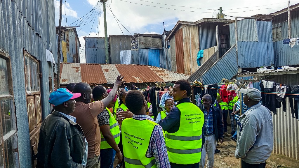 Programme site visit through narrow access routes in an informal settlement