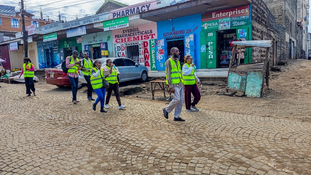 Team walking through Mathare Umoja neighbourhood streets, Kajiado County