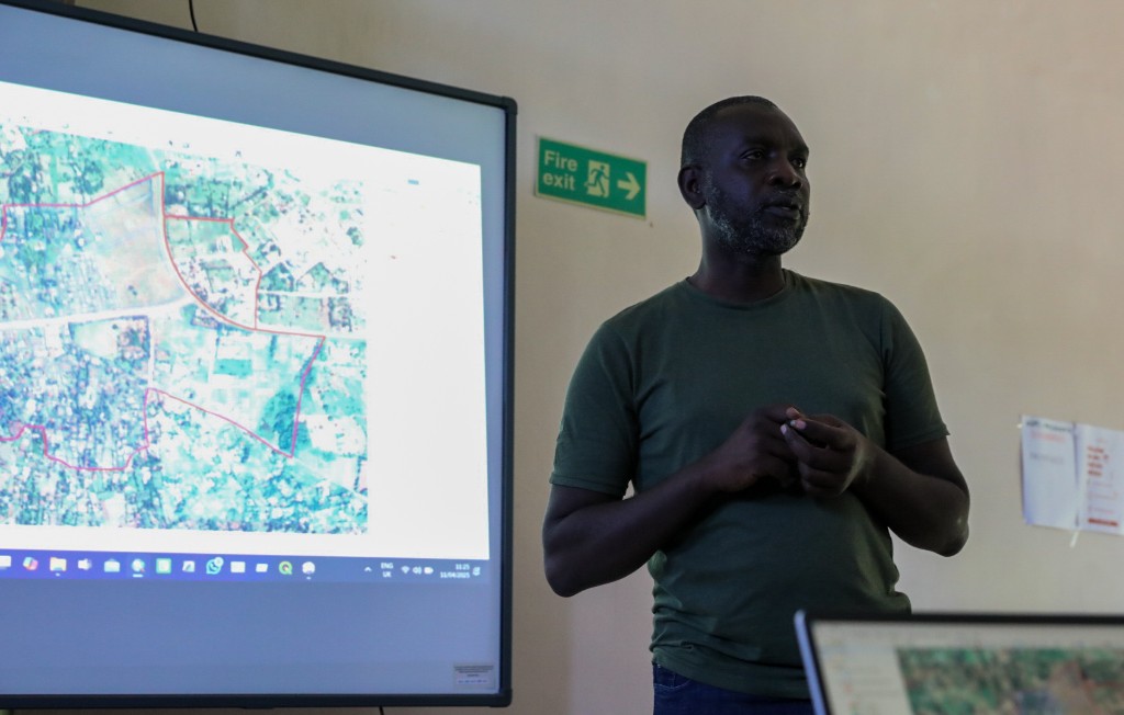 Facilitator presenting mapping and spatial data for settlement planning